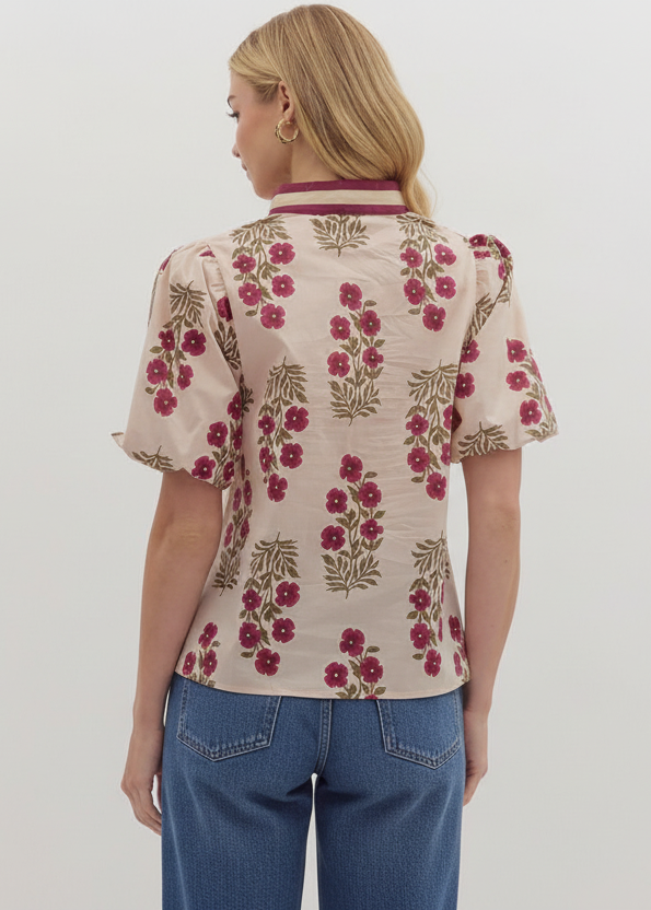 Woman wearing a floral blouse with a plain background