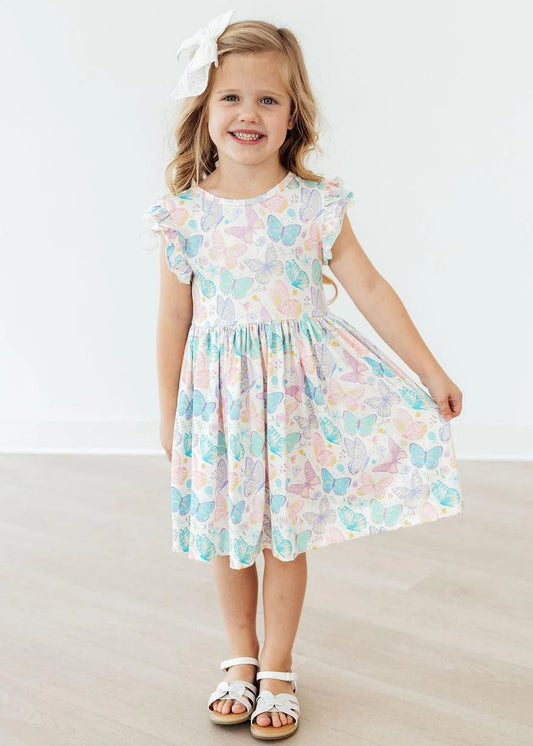 Young girl wearing a floral dress with a white background