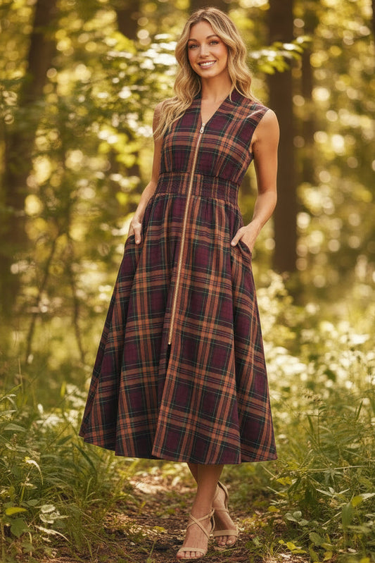 Woman wearing a plaid dress on a plain background