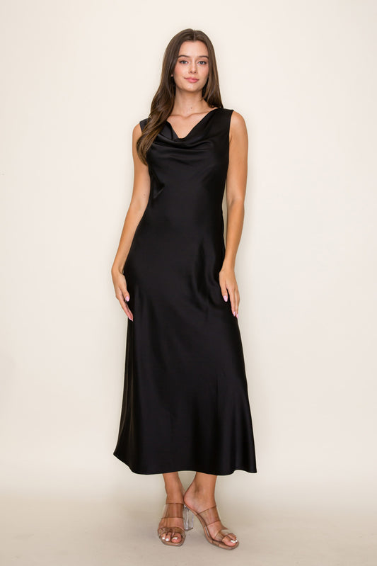 Woman wearing a black sleeveless dress against a beige background