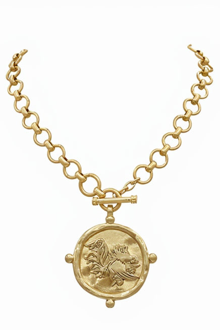 Gold necklace with a circular pendant on a white background