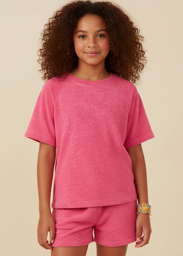 Young girl wearing a pink outfit on a beige background