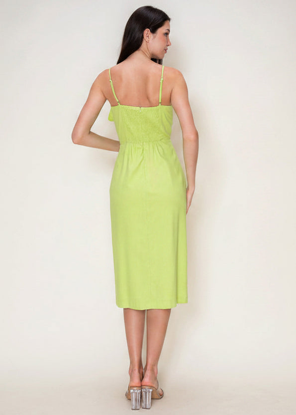 Woman wearing a light green dress against a white background