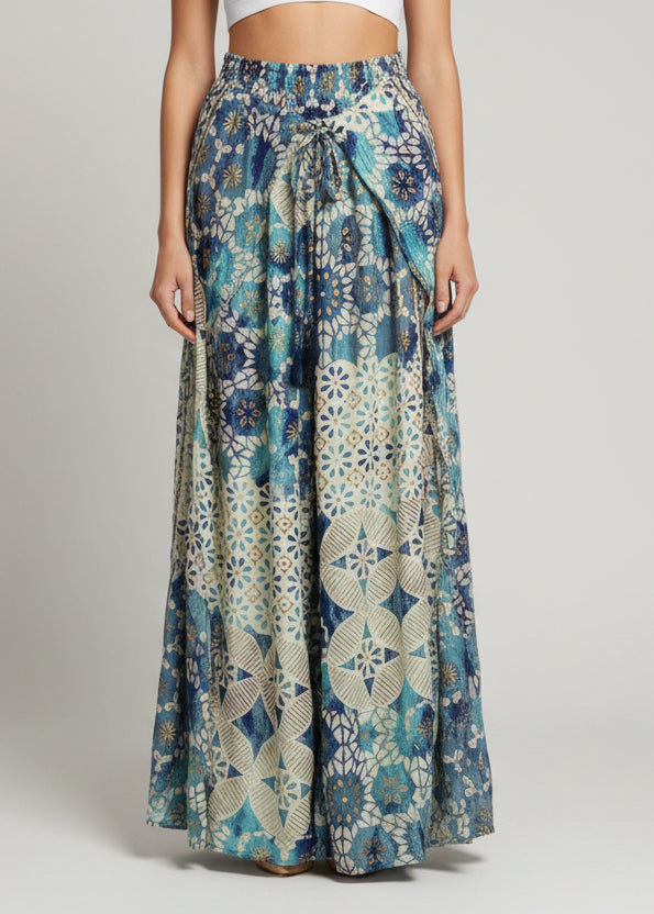 Folded fabric with blue and green patterns on a white background