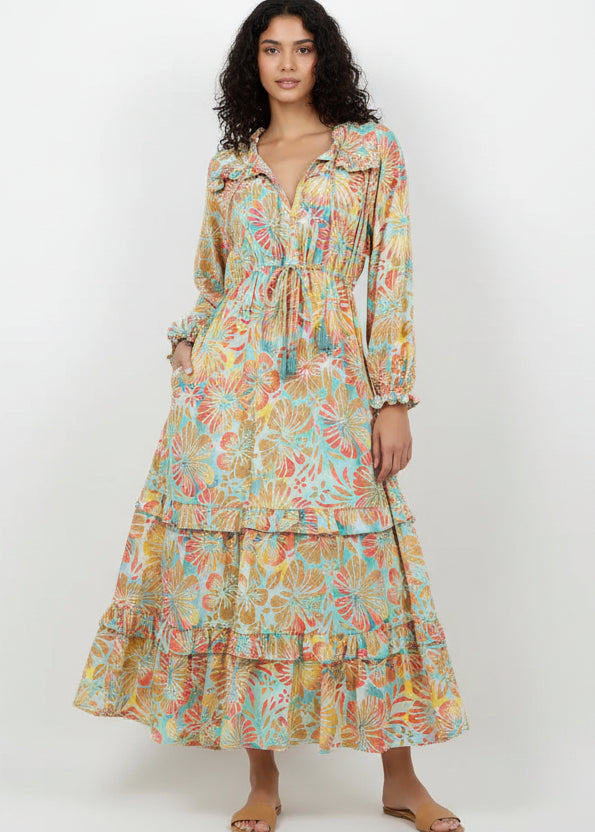 Woman wearing a colorful floral dress on a white background