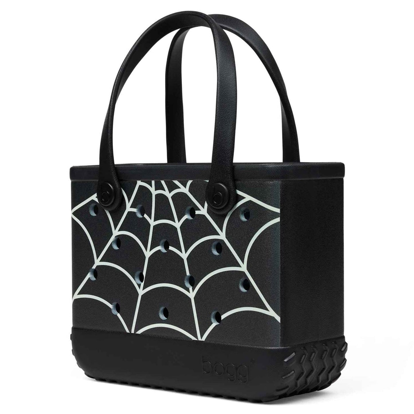 A black Bogg Bag with a white spiderweb pattern, featuring dual top handles and a textured base, shown on a plain white background.