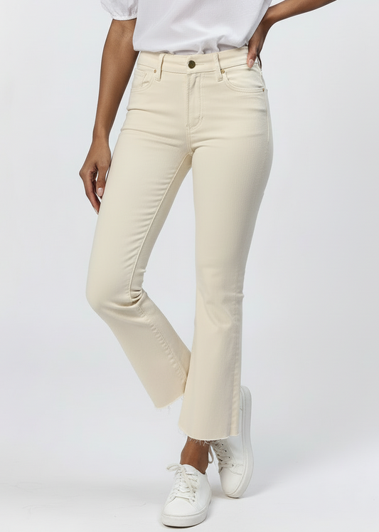 Person wearing beige pants and white sneakers on a white background