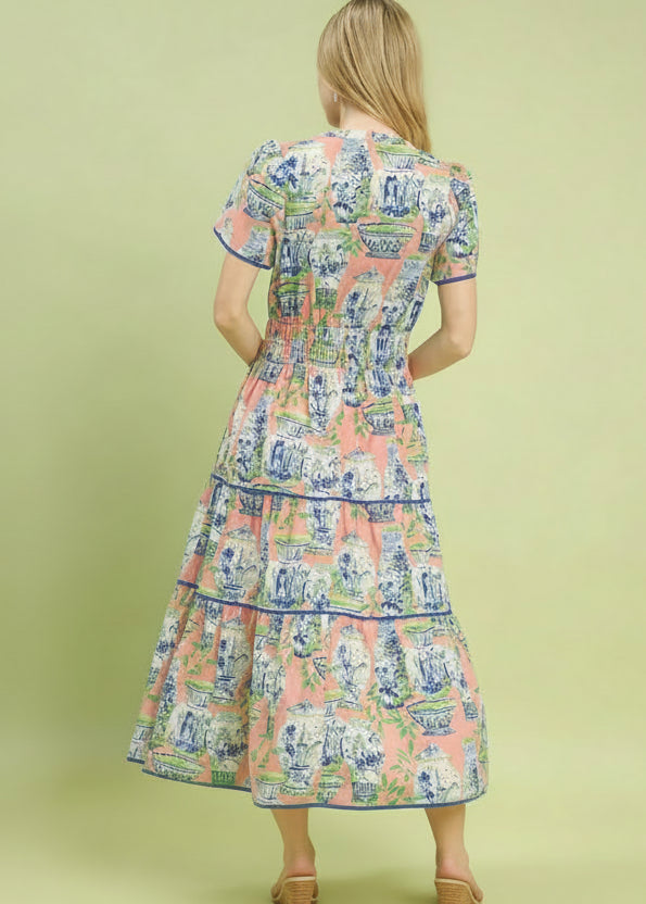 Woman wearing a patterned dress on a green background