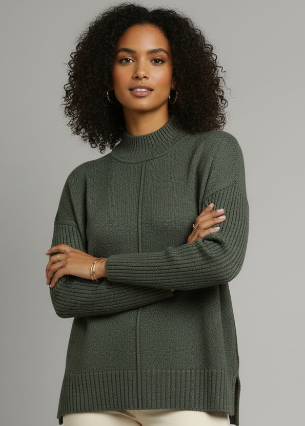 Woman wearing a green sweater against a gray background