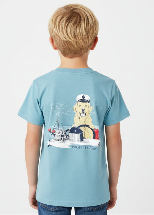 Light blue t-shirt with a dog on a boat graphic on a white background