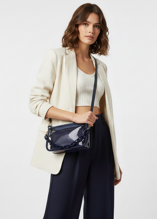 Navy handbag with a chain detail on a white background