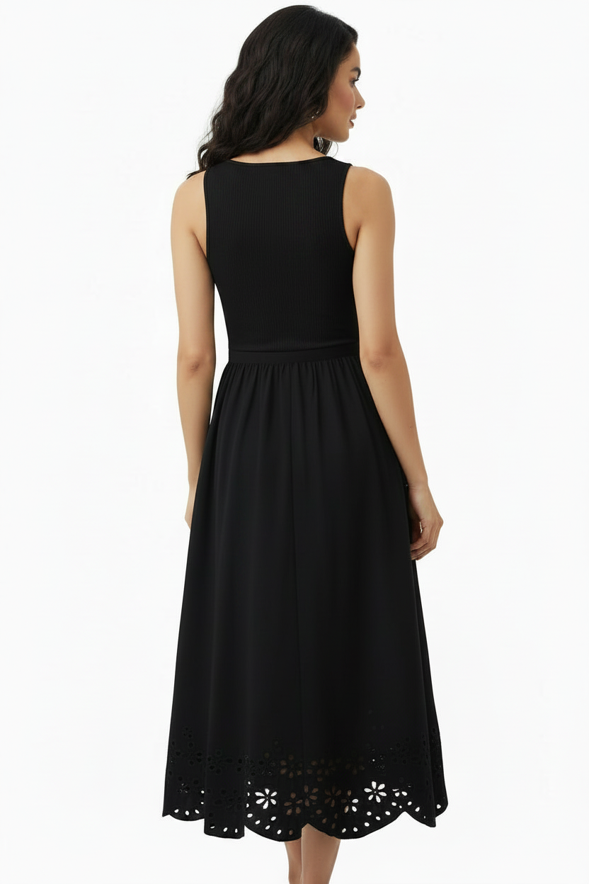 A woman shown from the back wearing a sleeveless black midi dress with a scoop neckline, gathered waist, and eyelet cutout scalloped hem against a plain white studio background.