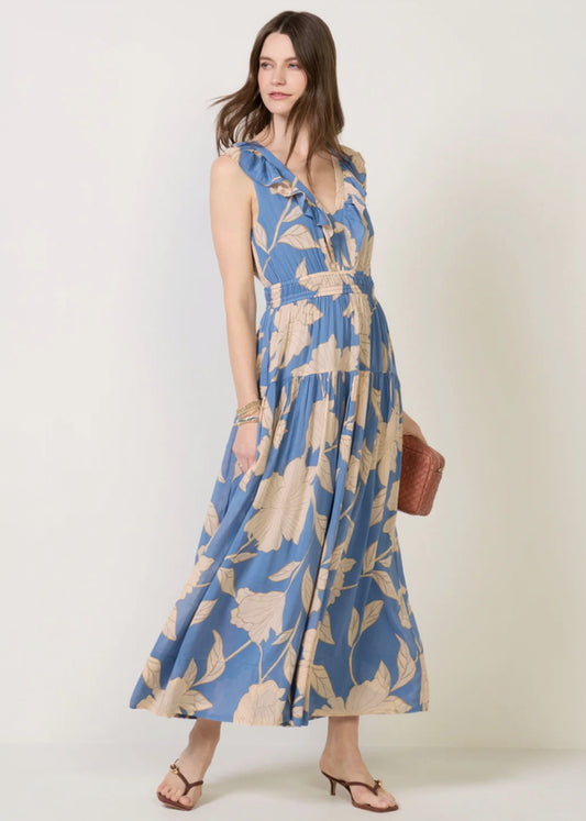 Woman wearing a blue floral dress against a white background