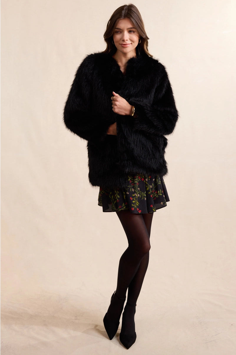 Luxurious faux fur coat that brings timeless elegance to any wardrobe. The Mathilde features plush, soft fur with a rich texture that captures the sophistication of genuine fur without compromise. Perfect for layering over dresses or pairing with casual pieces for an instant uplift in style. The classic silhouette can be dressed up for evening events or down for weekend sophistication. Versatile enough to complement both polished and relaxed looks.
