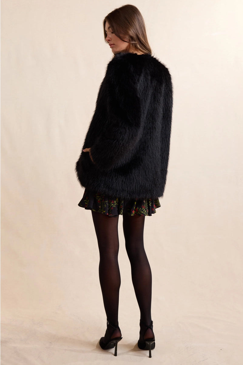 Luxurious faux fur coat that brings timeless elegance to any wardrobe. The Mathilde features plush, soft fur with a rich texture that captures the sophistication of genuine fur without compromise. Perfect for layering over dresses or pairing with casual pieces for an instant uplift in style. The classic silhouette can be dressed up for evening events or down for weekend sophistication. Versatile enough to complement both polished and relaxed looks.
