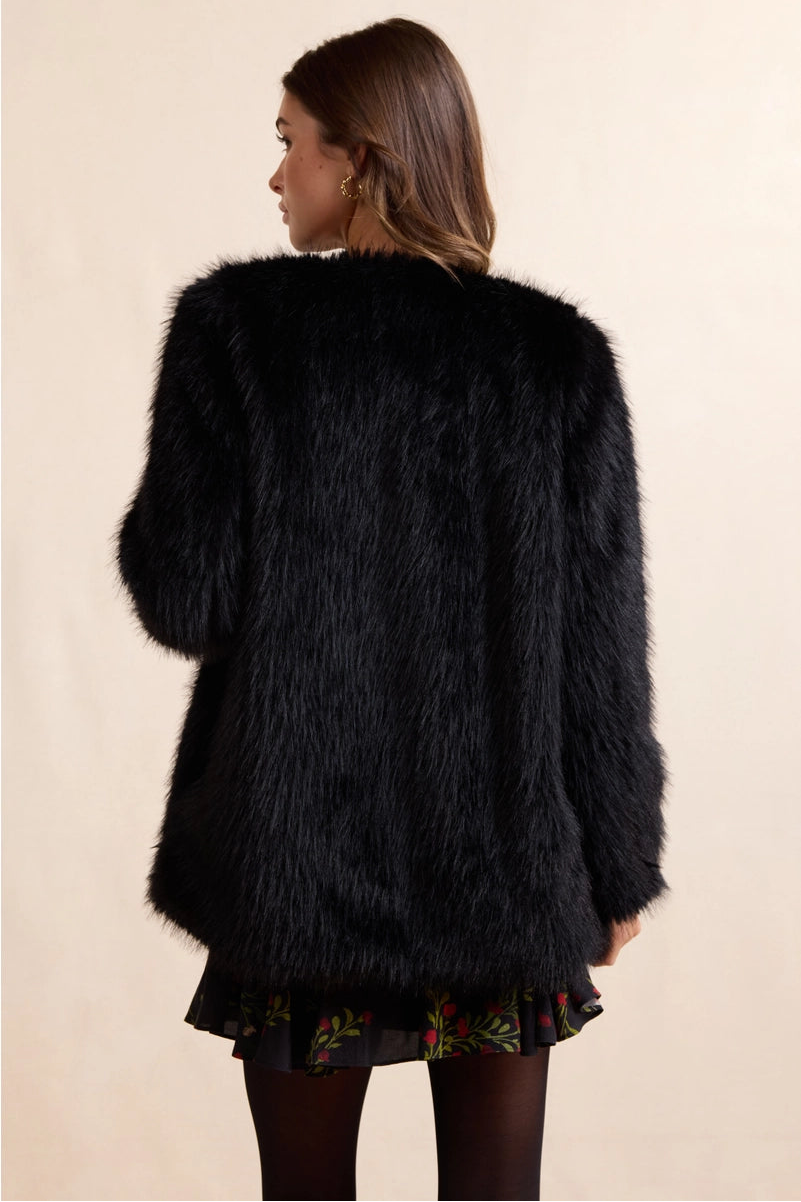 Luxurious faux fur coat that brings timeless elegance to any wardrobe. The Mathilde features plush, soft fur with a rich texture that captures the sophistication of genuine fur without compromise. Perfect for layering over dresses or pairing with casual pieces for an instant uplift in style. The classic silhouette can be dressed up for evening events or down for weekend sophistication. Versatile enough to complement both polished and relaxed looks.