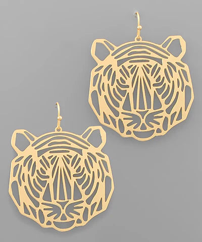 A pair of gold-toned tiger head dangle earrings with intricate cutout detailing, displayed against a solid gray background.
