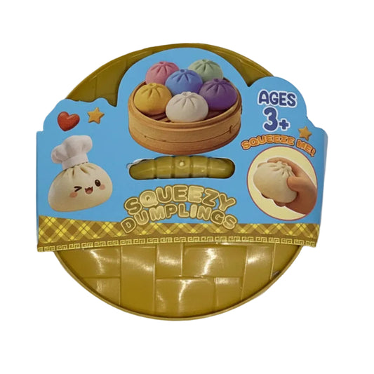 A packaged toy set of squishy dumplings shaped like buns and steamed buns, shown in a round blister pack with a blue printed label. The package includes a translucent yellow dumpling and a small yellow rolling pin, with cartoon illustrations of buns and text reading 'Squezy Dumplings' and 'Ages 3+'.
