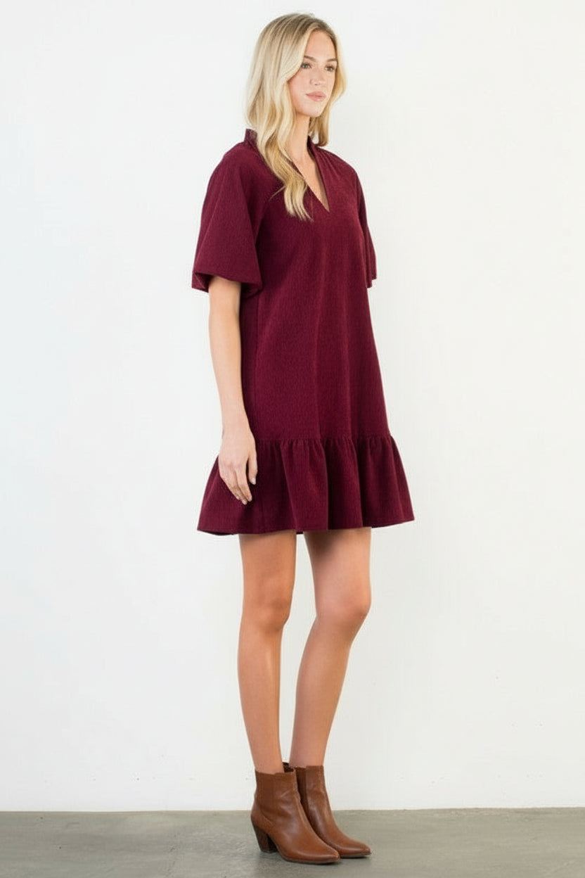Woman wearing a burgundy dress on a white background