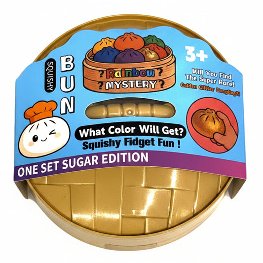 A packaged toy product labeled 'BUN Rainbow Mystery' on a white background. The item appears to be a squishy fidget toy inside a gold foil bun-shaped container, wrapped with a colorful paper label showing cartoon bun graphics, text about 'Rainbow Mystery,' and 'One Set Sugar Edition.
