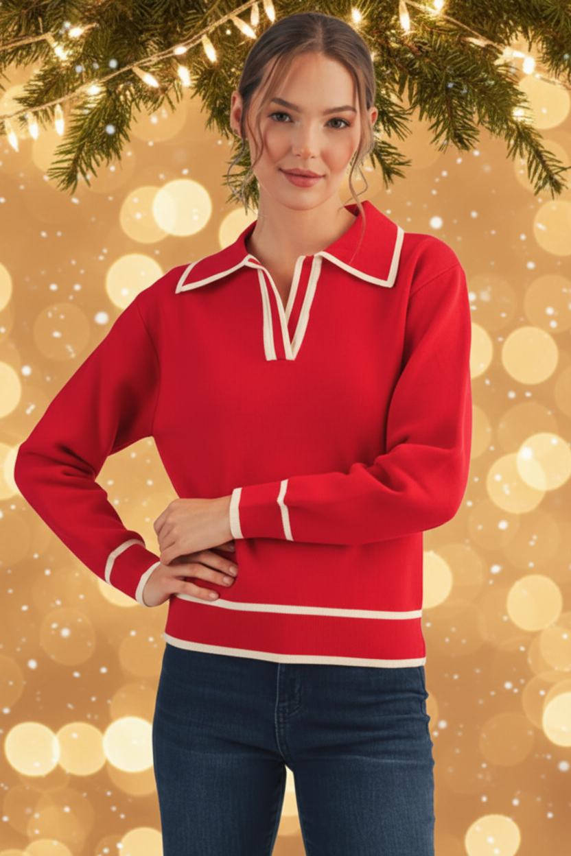 Woman wearing a red sweater with white trim against a festive background with lights and snow.