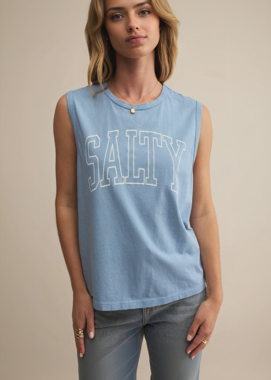 Person wearing a blue sleeveless shirt with 'SALTY' printed on it against a beige background