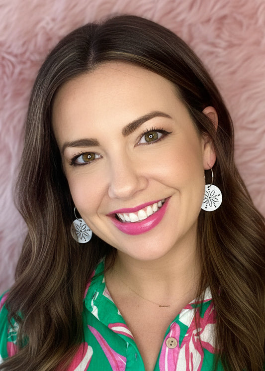 Woman with a floral shirt against a pink textured background