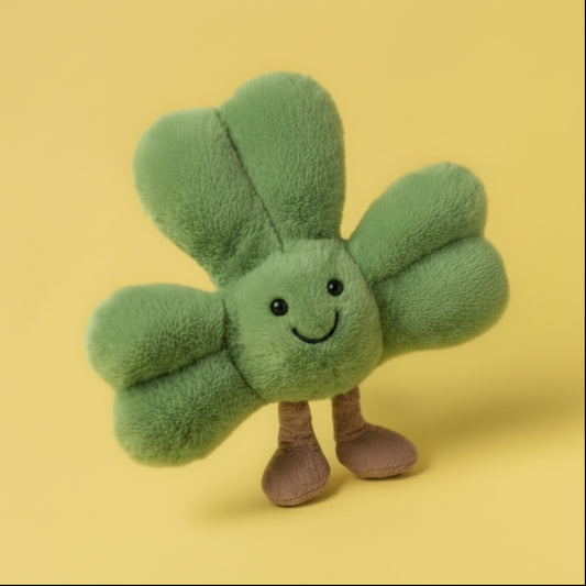 Green plush toy with a smiling face on a yellow background, labeled 'NEW DROP'.