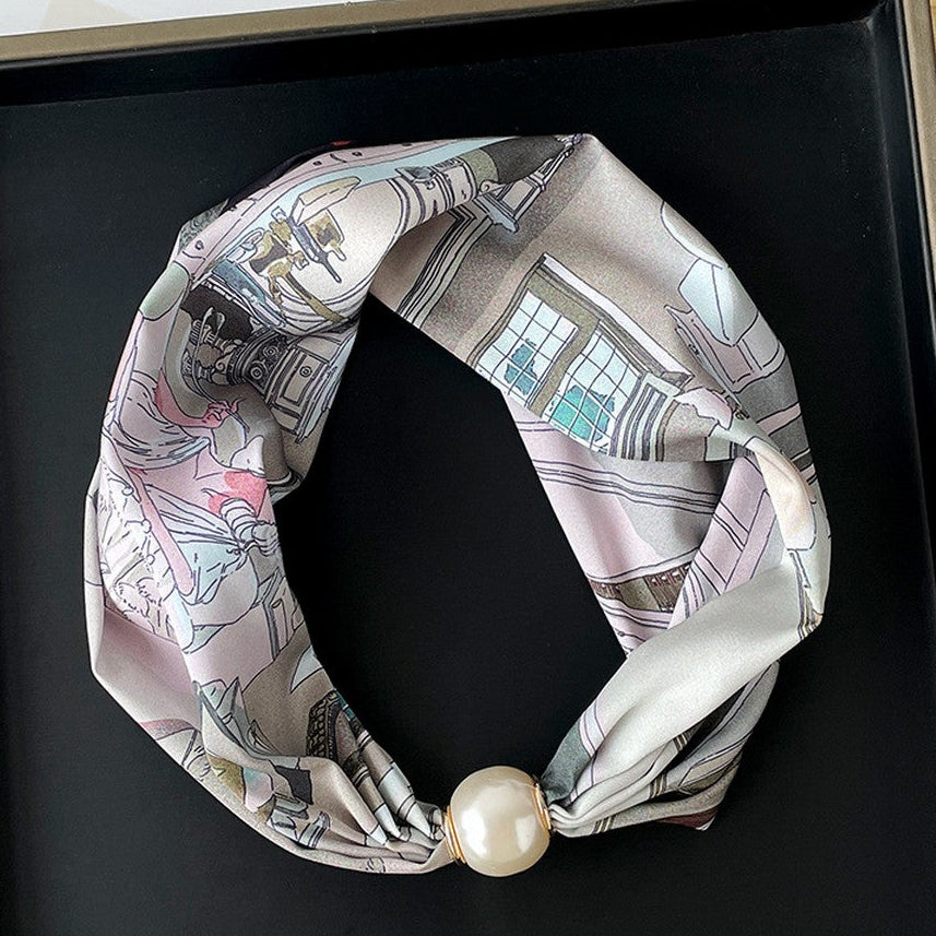Necklace with a patterned scarf and pearl-like bead on a black background