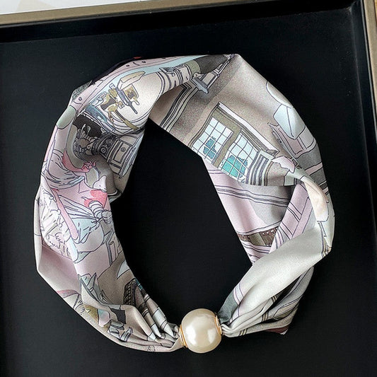 Necklace with a patterned scarf and pearl-like bead on a black background