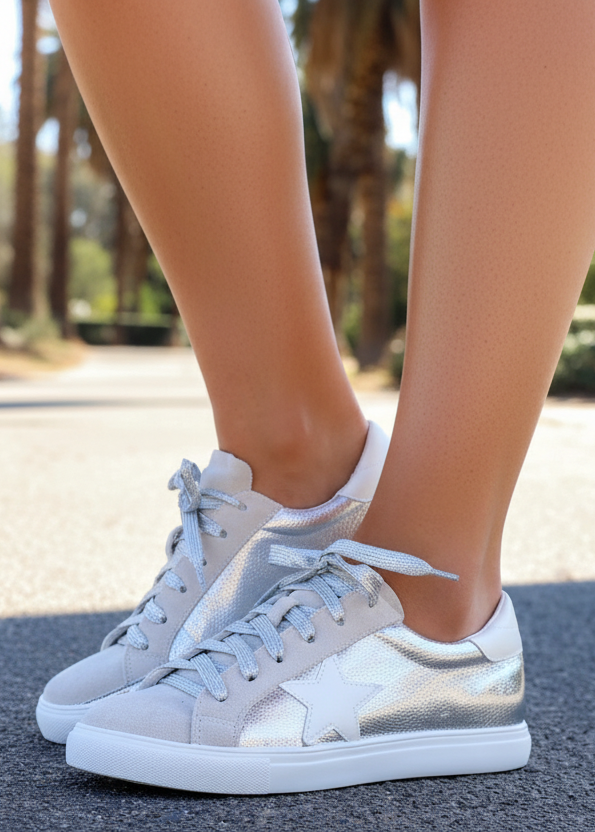 Gray and white sneakers worn outdoors with blurred background