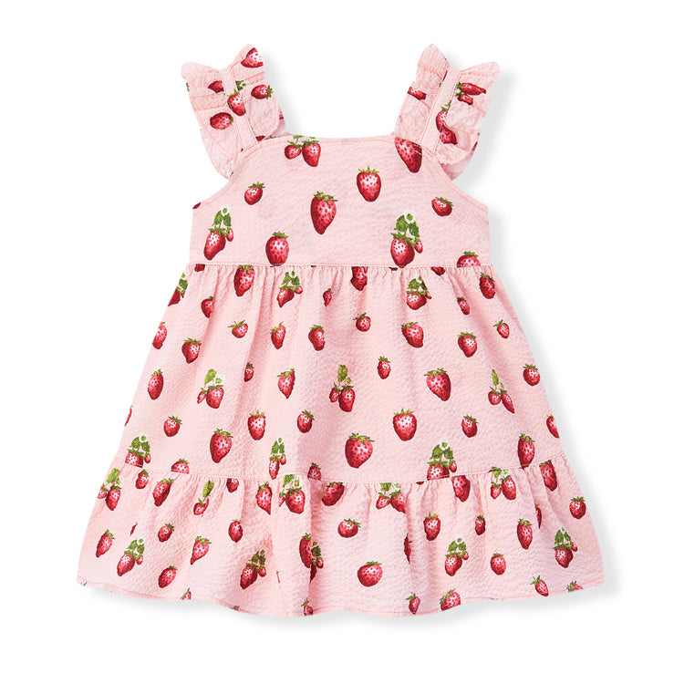 Pink dress with strawberry pattern on a white background