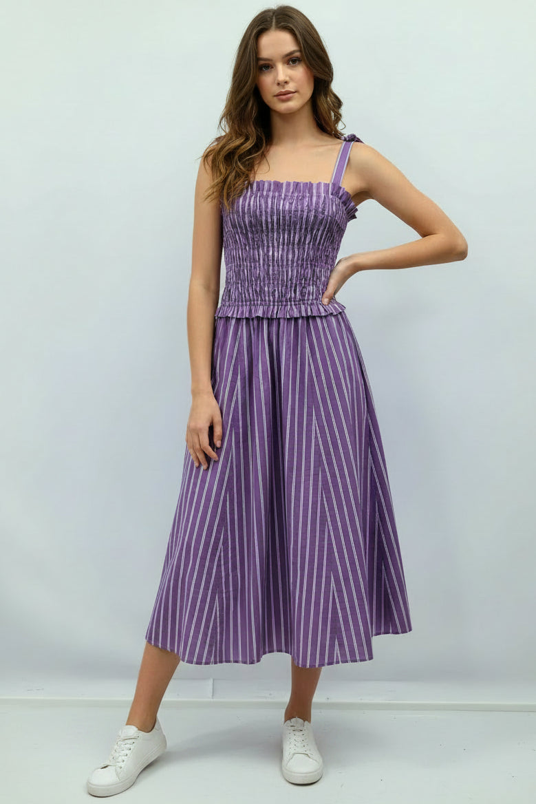 Purple striped dress on a mannequin against a light gray background
