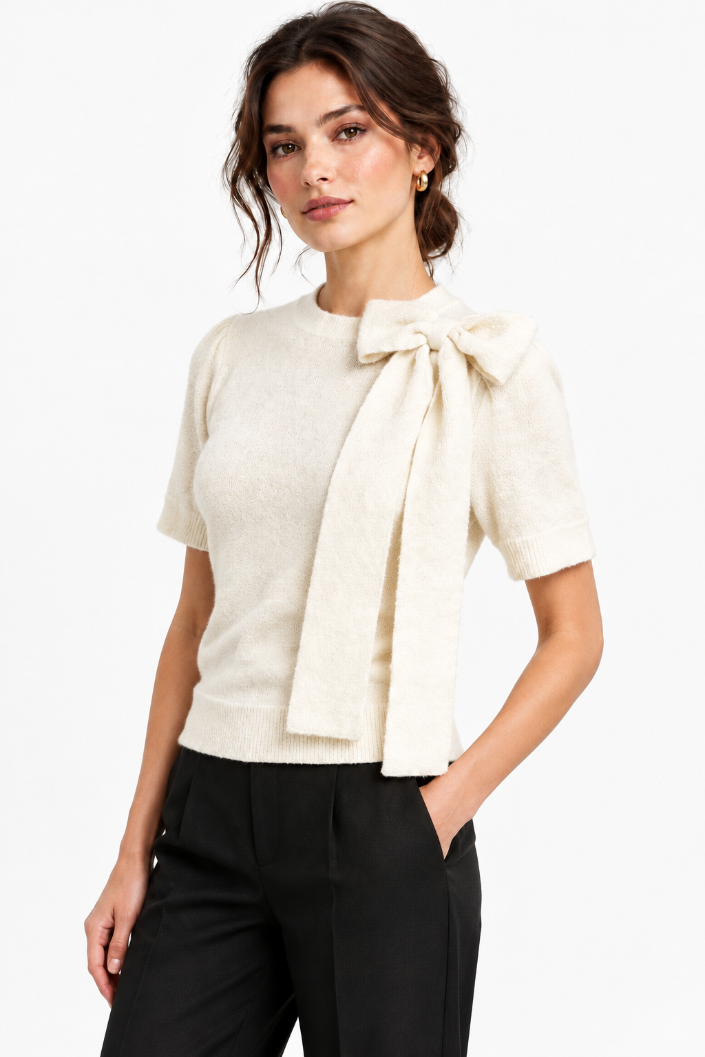 This ivory crew neck sweater features an elegant oversized tie neck bow and short puffed sleeves for a modern, feminine silhouette. Crafted from a breathable acrylic blend with plenty of stretch, it's designed for comfort and easy movement. Perfect for layering or wearing solo.