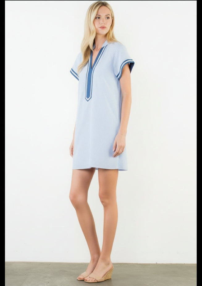 Woman wearing a light blue dress with a white background