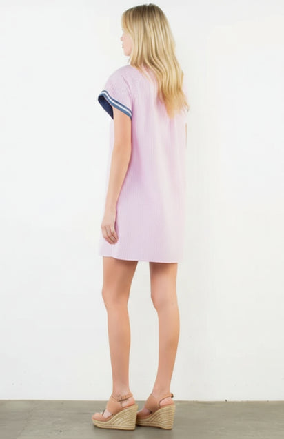 Woman wearing a light purple dress with a white background