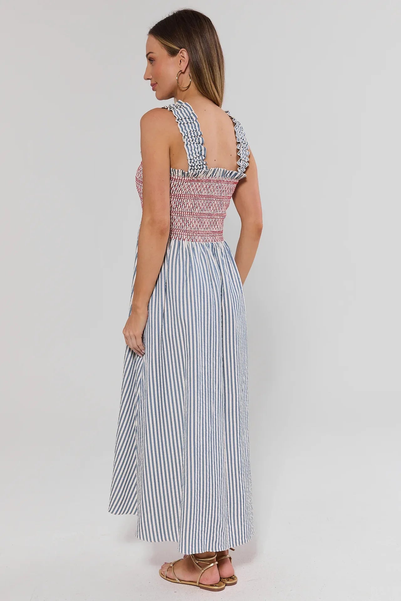 Woman wearing a striped dress with a white background