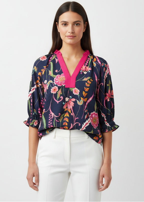 Floral dress with pink accents on a mannequin against a white door background