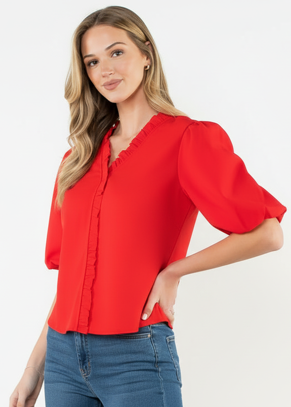 Woman wearing a red blouse with puff sleeves on a white background