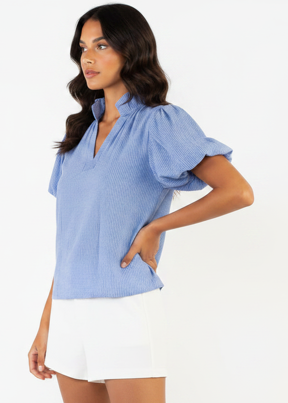Woman wearing a blue checkered blouse with short sleeves on a white background