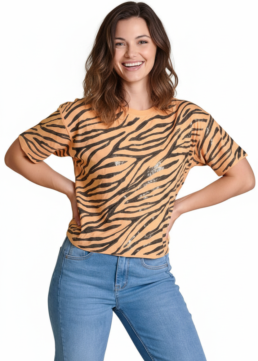 Woman wearing a tiger stripe shirt and blue jeans on a white background