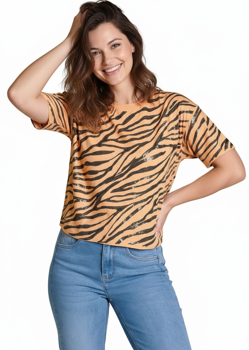 Woman wearing a tiger-striped shirt and blue jeans on a white background