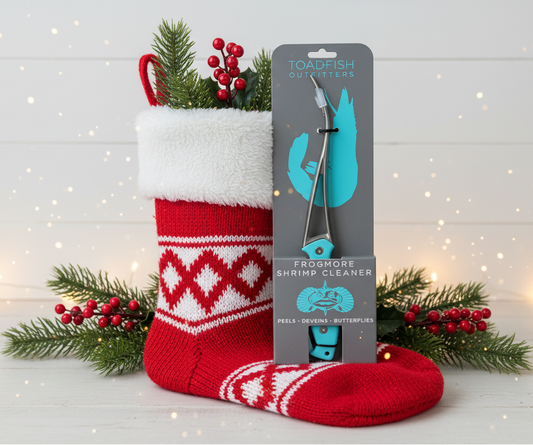 Red and white Christmas stocking with a turquoise shark fin cleaner and packaging on a wooden surface.