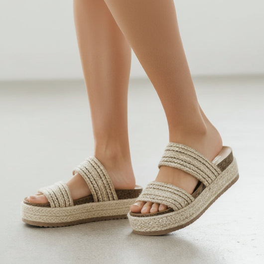 Pair of woven sandals on a white background
