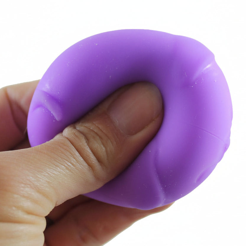 Purple stress ball being held in a hand with 'Curious Minds' branding.
