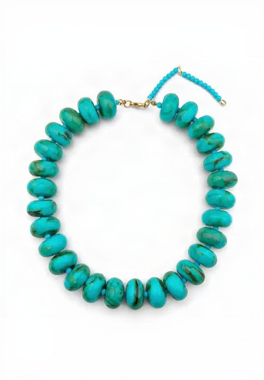 A turquoise beaded necklace with large, rounded disc-shaped beads and a gold-tone clasp, displayed on a clean white background.