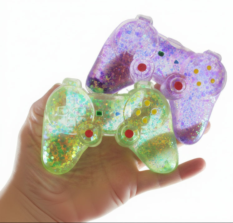 Colorful glittery toy controllers held in a hand with 'Curious Minds Busy Bags' branding.
