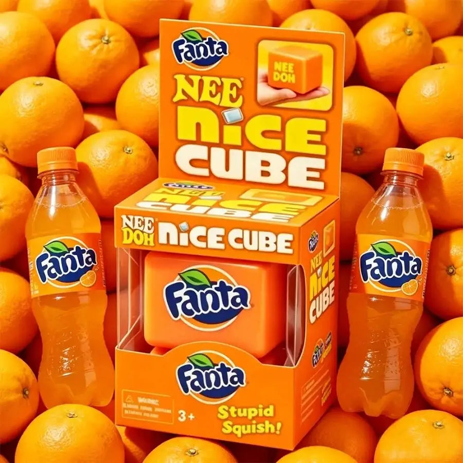 Fanta Nee Nice Cube packaging surrounded by oranges