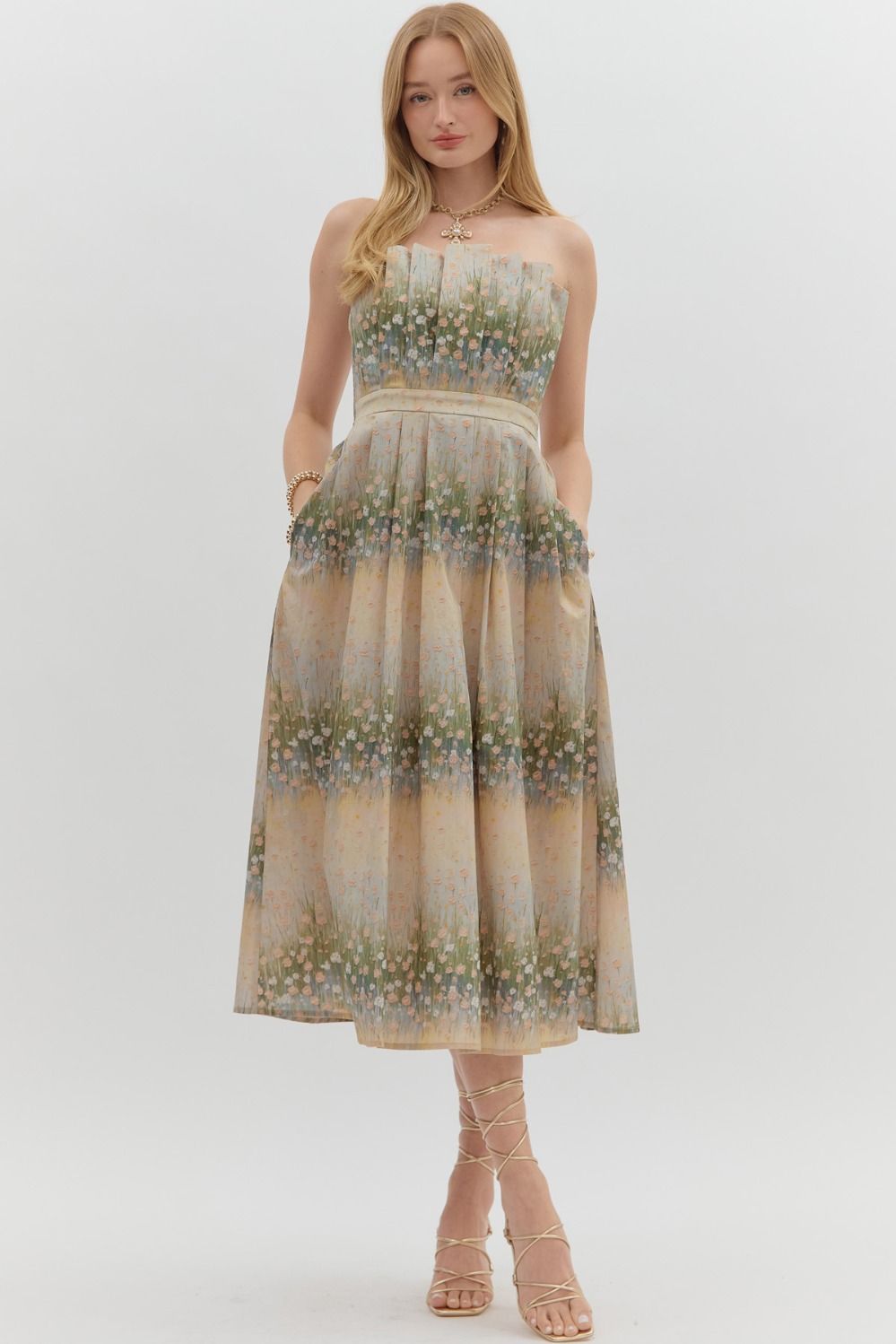 Woman wearing a floral strapless dress on a white background