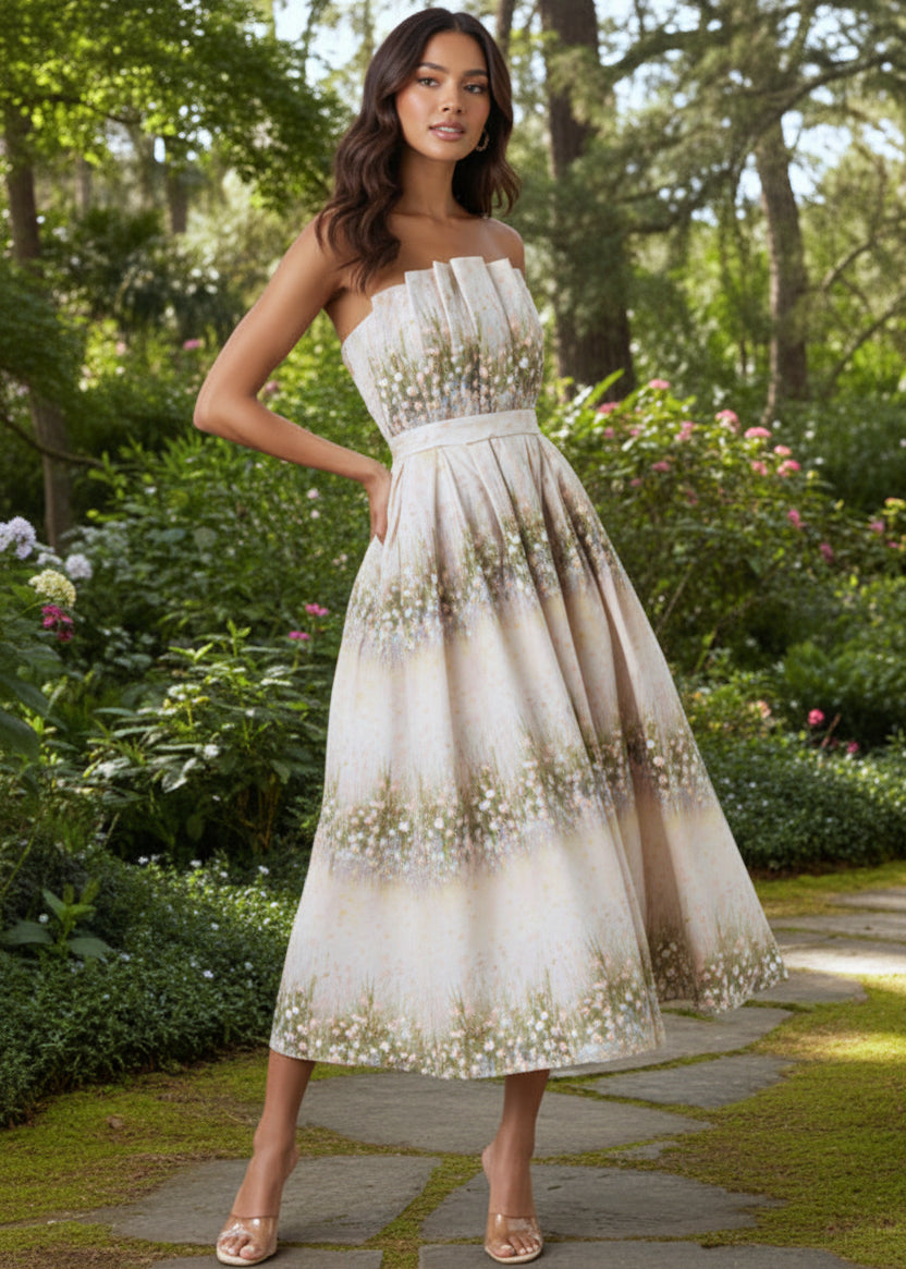 Woman in a strapless floral dress standing in a garden